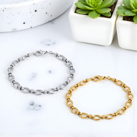Bracelet homme maillons ovales dore argent poignet presentation marbre plantes
