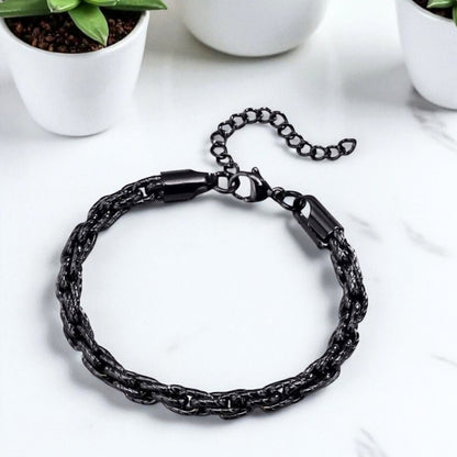 Bracelet homme motifs serpent noir table blanche plantes presentation dessus