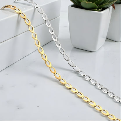 CHAINE HOMME MAILLE OVALES argent dore presentation plantes table blanche