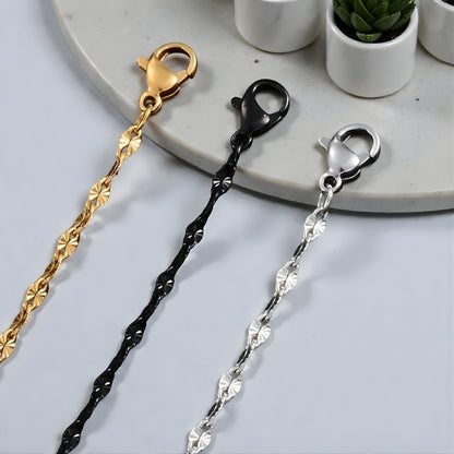 CHAINE HOMME MAILLONS OVALE FORMES D'ŒIL variantes argent dore noir presentation marbre fermoir