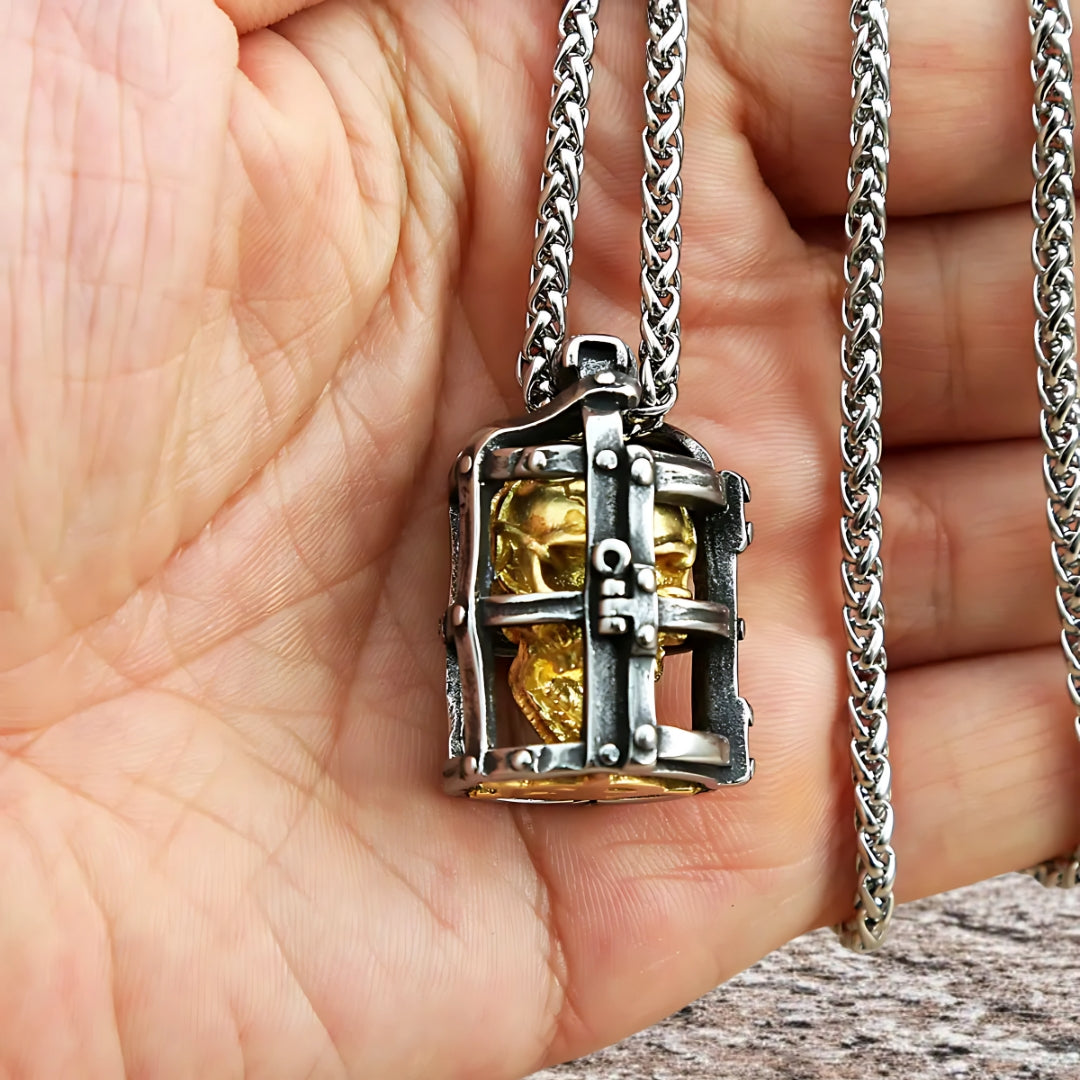 Collier homme, pendentif SKULL CAGE™ variante acier dore main 