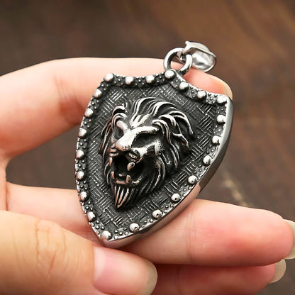 Collier hommes, pendentif BOUCLIER LION II™ presentation entre les doigts