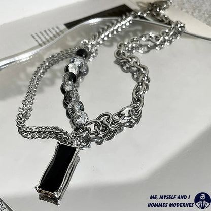 homme luxe, pendentif L'Ombre d'Ébène  rectangle rectangle table blanche